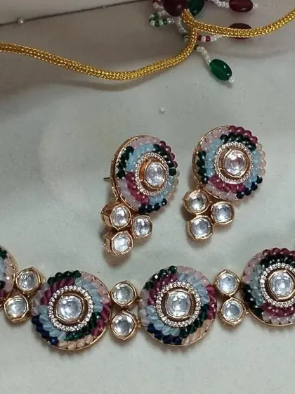 This unique necklace set features multi-color thread work around each kundan setting. It's a modern twist on a classic design, perfect for someone who wants a colorful and contemporary piece.