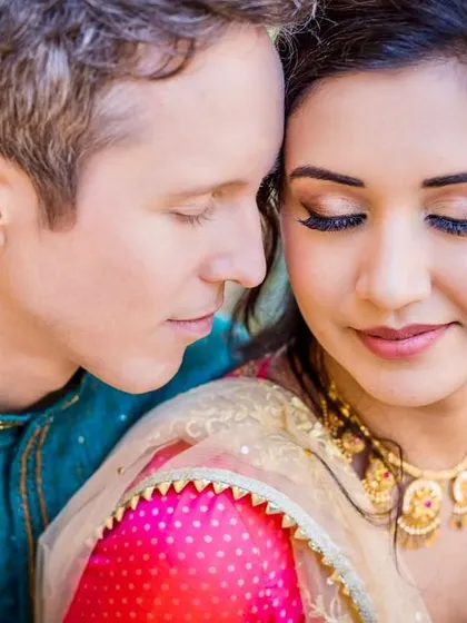 An intimate close-up of the couple. Their closed eyes and gentle touch convey a sense of peace and deep connection.