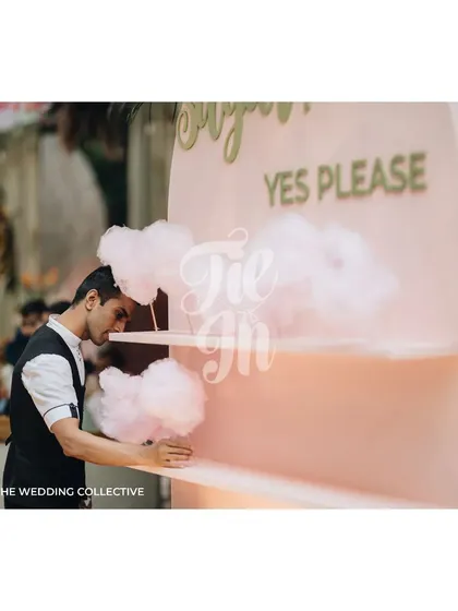 Even the fun stations get a design upgrade. This "Sugar? Yes Please" cotton candy stand was designed with a custom pastel pink backdrop to perfectly match the boho-chic theme of the Mehendi event.