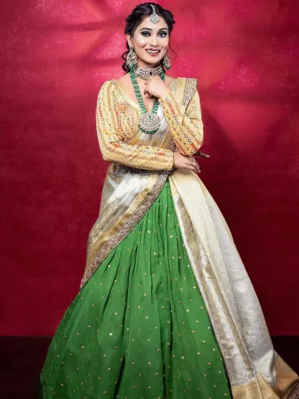 A full-length view of this unique reception outfit. The way the dupatta is draped like a saree pallu gives it a very graceful and contemporary feel.