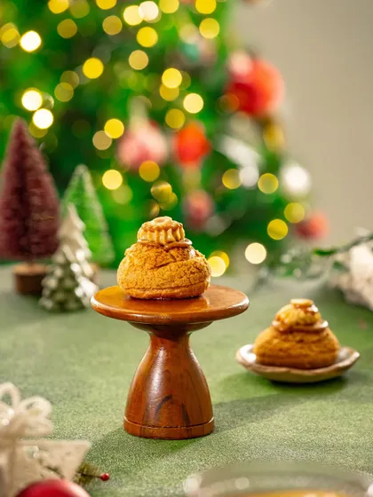 A clean, well-lit shot of Christmas pastries against a festive, out-of-focus background, highlighting the treats themselves.