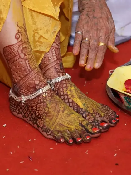 The deep color of the henna stain is beautifully highlighted during this bride's haldi ceremony.