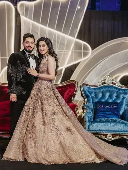 A full-length portrait of the couple at their reception, looking elegant and regal.