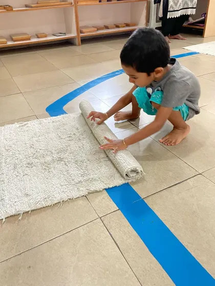 Rolling and unrolling a work mat is one of the first and last things a child does for any activity. This simple, repetitive motion builds gross motor skills, teaches respect for the workspace, and establishes a sense of order.