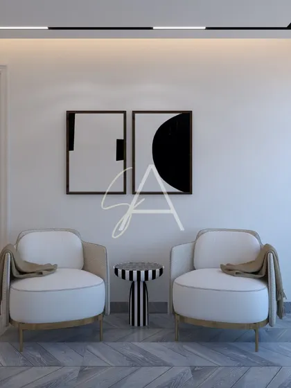 A quiet seating nook designed with minimalist principles. The simple armchairs, geometric side table, and abstract black-and-white art create a sophisticated and contemplative corner.
