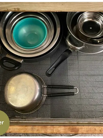 After decluttering and organizing, the pots and pans are nested neatly, creating more space and making every item easy to access.