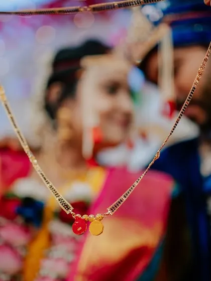 A symbolic shot focusing on the Mangalsutra, a centerpiece of the Maharashtrian wedding ceremony. Capturing these crucial details is essential to telling the complete story of your union.