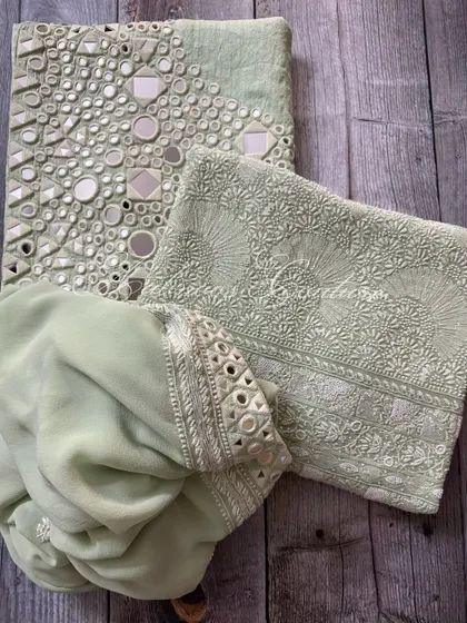 A flat-lay of the complete mint green set, including the kurta, palazzo, and dupatta.