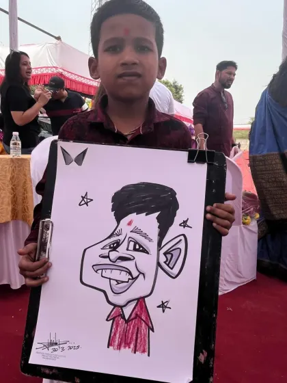 A young boy holding his caricature at an outdoor event. It's a fun souvenir for kids to take home.
