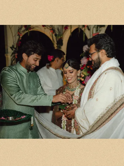 A candid moment from Mouli and Jaymit's wedding ceremony, filled with smiles and the warmth of family participation.