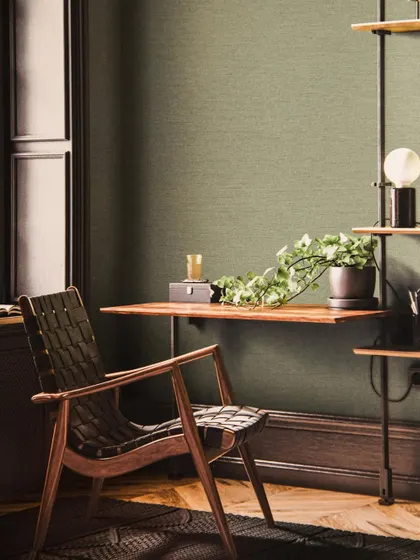 A serene and sophisticated study or home office. The sage green textured wallpaper pairs beautifully with dark wood furniture, creating a calm and focused environment that is both stylish and professional.