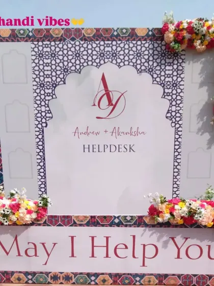 The helpdesk at a Mehendi event, designed with a beautiful floral and patterned backdrop. We ensure even the smallest details are themed and perfectly executed for a seamless guest experience.