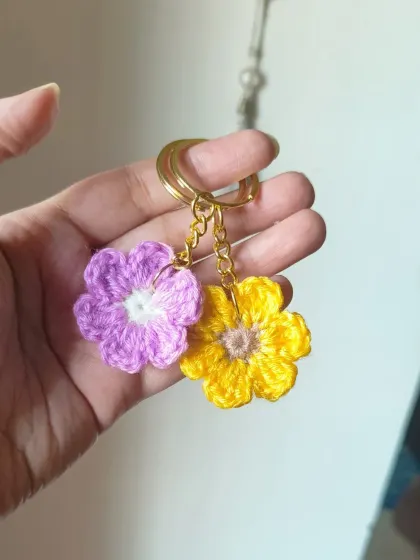 A pair of our floral keychains in lavender and yellow.