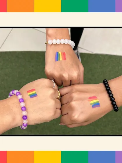 A symbol of unity and support, with participants showing off their Pride-themed bracelets and temporary tattoos.