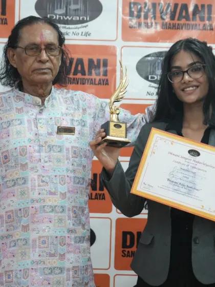 A senior guru with his student, celebrating her success.