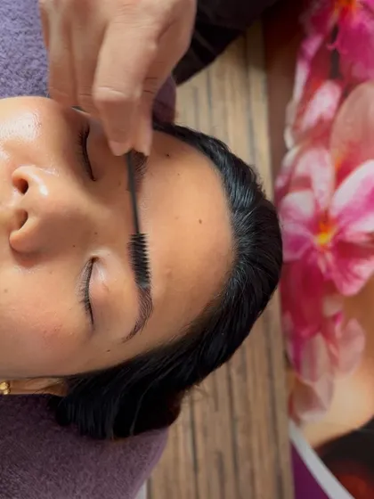 A snapshot of the final step in a microblading session: brushing the brows. This simple action showcases the natural look and texture of the finished work.