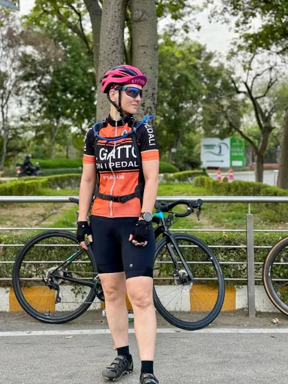 A full-length shot of a rider with her LOOK bike.