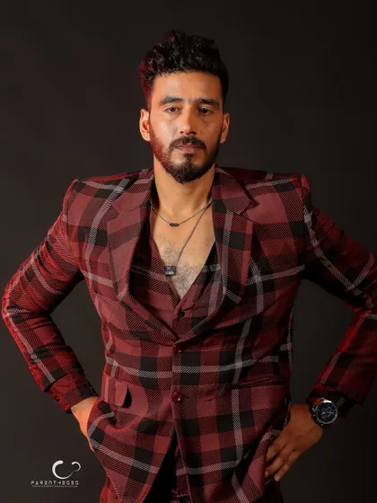 A strong, symmetrical pose that conveys power and stability. The lighting from the side adds dimension to the plaid pattern.