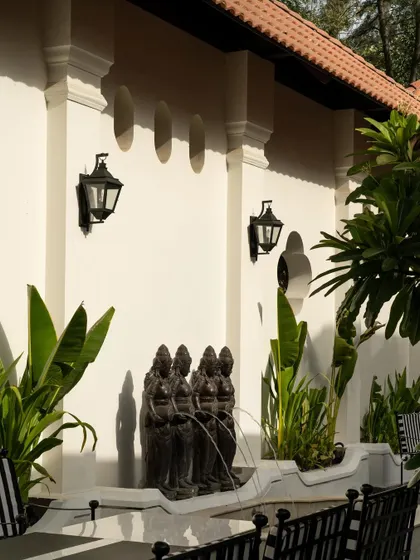 Views of the courtyard at Elgin Cafe, a space designed for pause and reflection. I used white lime-washed walls, lush tropical plants, and classic lantern-style lighting to create an intimate, serene outdoor dining experience.