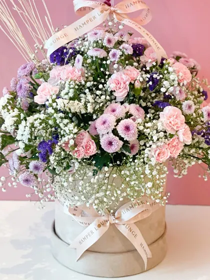 A detailed look at the fresh floral arrangement, showcasing the mix of pink carnations, purple asters, and delicate baby's breath. I use only the freshest blooms to ensure every arrangement is beautiful and long-lasting.