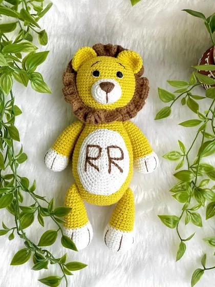 A royal lion plushie, personalized with the initials "RR" on his belly. This majestic friend is ready to rule the playroom with kindness.
