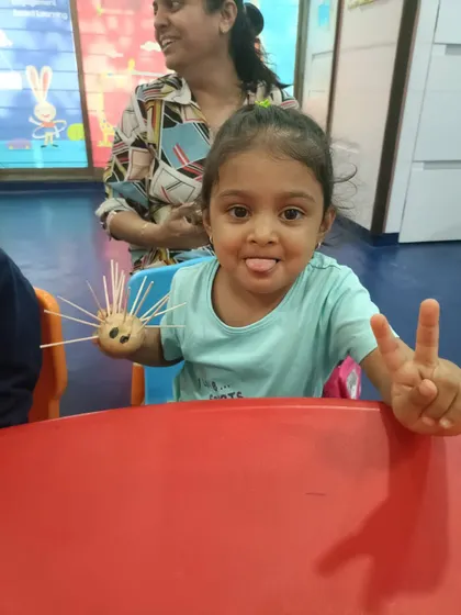 A proud little artist shows off her creation made from a potato and toothpicks. This hands-on craft is a great example of how we develop fine motor skills and encourage creativity in a playful way.