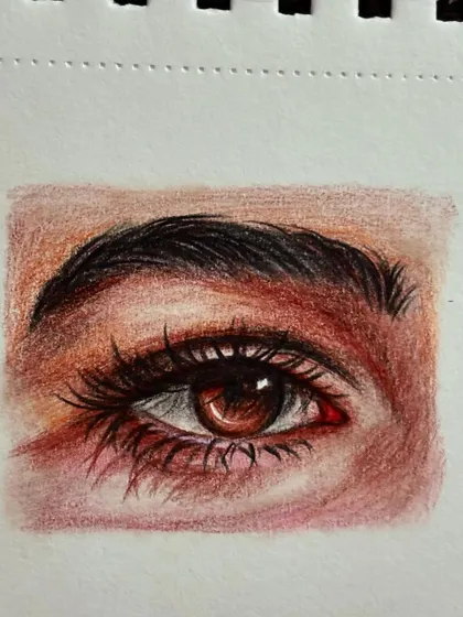 The full drawing of the realistic eye, done with color pencils on a sketchbook page.
