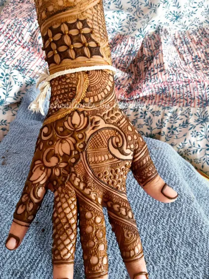 Even a single hand of mehendi can be a work of art. This design features a beautiful lotus flower on the palm, surrounded by delicate patterns that extend up the wrist.