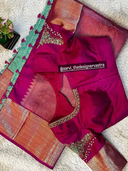 The complete look of the pink blouse with its matching silk saree. The tassels and embroidery are perfectly coordinated.