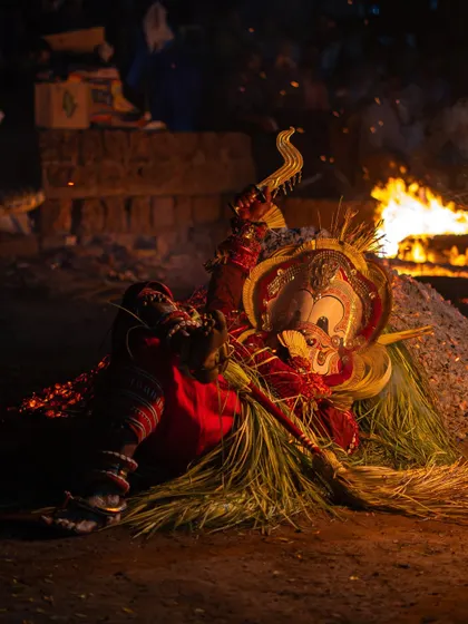 A series capturing the different stages of the Pottan Theyyam ritual, from the performer lying on the embers to being tended to by assistants. These images show the intensity and devotion involved in the all-night ceremony.