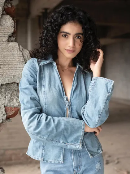 The makeup is subtle enough to look completely natural, perfect for a casual denim-themed shoot.
