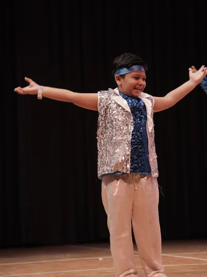 The joy on their faces says it all. A young performer from our 'Dancing Rockets' group, having the time of his life on stage.