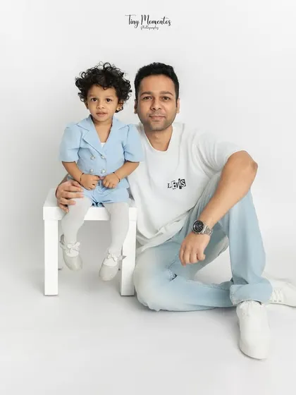 Capturing the special bond between a father and his daughter. This simple, seated pose allows for a quiet moment of connection, resulting in a timeless dad and daughter portrait.