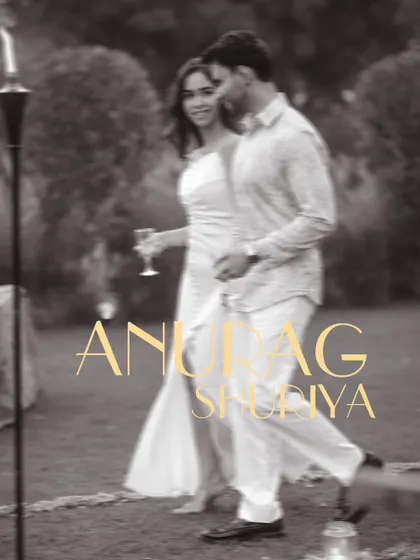 A candid, black and white pre-wedding shot capturing a spontaneous moment of joy.