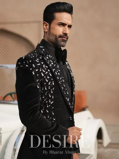 A classic black tuxedo elevated with scattered silver and crystal embroidery on the lapels. This piece is for the man who appreciates timeless style with a touch of modern glamour.