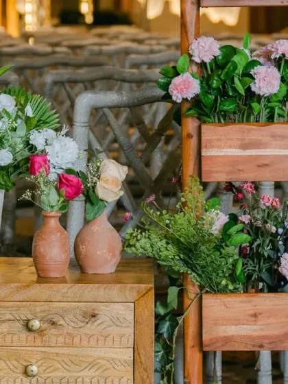 A close-up of the charming details from a rainy wedding day. The combination of pastel florals in rustic, handmade pots creates a look that is both simple and incredibly beautiful.