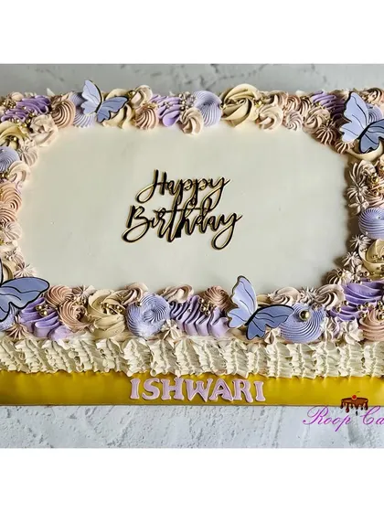 A lovely sheet cake decorated with pastel purple and beige rosettes and delicate butterflies.