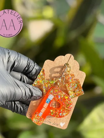 This keychain features a star and square charm along with the initial. The possibilities for customization are endless.