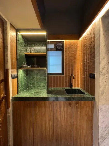 We also used Baroda Green Marble for the pantry, pairing it with warm wood cabinetry and LED strip lights. This project is our way of showing how beautiful design can be achieved with simple, homegrown materials.