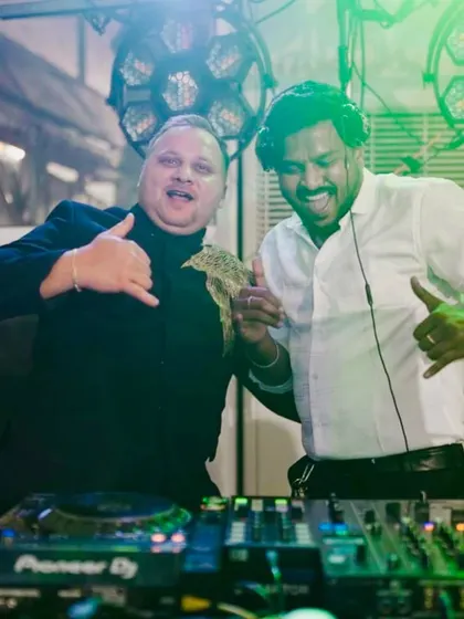 Sharing a laugh with a guest behind the decks. I'm not just a DJ who plays music; I engage with the crowd, take requests, and make sure everyone is having a fantastic time.