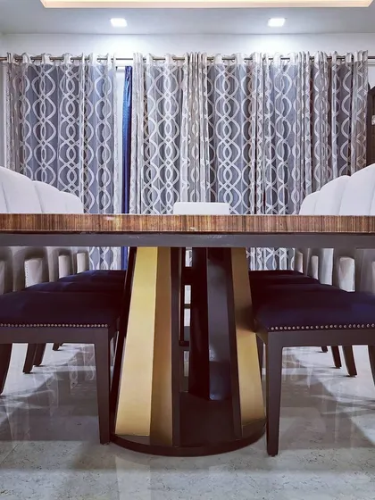 The formal dining room in Villa 9/21B, featuring a custom-made table with a striking metallic base and upholstered chairs. This space was designed for sophisticated entertaining, with careful attention to material and form.