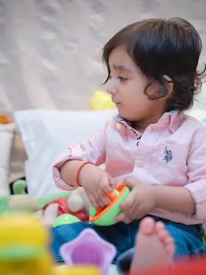 A duplicate image showing the toddler deeply engaged in playtime, a perfect example of our candid photography style.