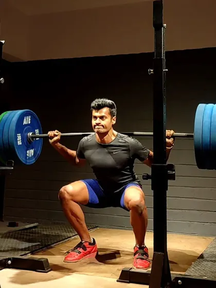 A front view of a heavy back squat. Proper form means keeping the chest up, core braced, and knees tracking over the feet. This is the posture that builds strength safely.