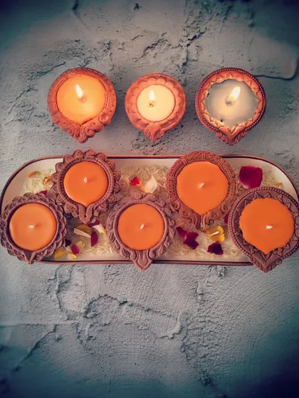 My tri-color Diya Candles, lit and unlit, arranged on a platter. The saffron, white, and green colors were chosen to honor the Ayodhya temple inauguration, creating a patriotic and spiritual ambiance.