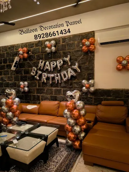 A modern and minimalist birthday decoration using chrome copper and silver balloons. The simple balloon clusters are placed strategically to decorate the living space.