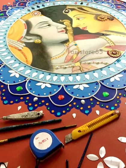 A close-up of the Lippan art process, showing our tools, reference designs, and the detailed painting around the central image. Each element is carefully planned and executed by hand.