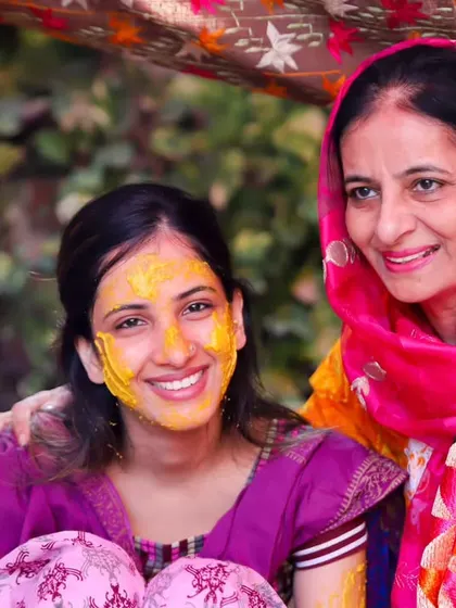 A beautiful portrait of a bride and her mother at the Haldi ceremony. Their smiles radiate warmth and happiness, a perfect Mother's Day tribute.
