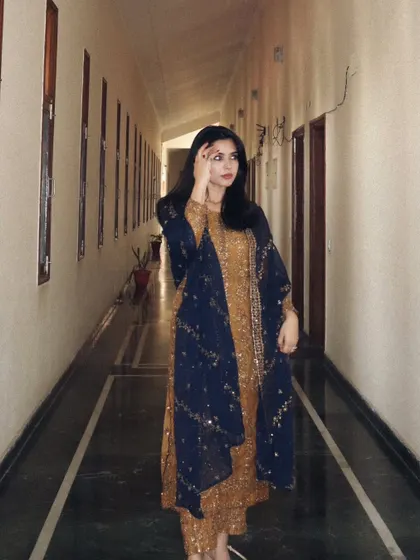 Another pose in the Asim Jofa designer suit, showing the intricate detail of the ethnic wear.