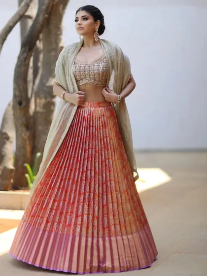 A modern take on festive wear. This pleated lehenga is styled with simple yet elegant earrings, showing that sometimes less is more.