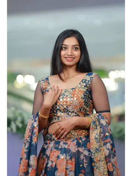 A lovely portrait in the floral lehenga, showcasing the mirror work on the blouse and the delicate print. It's a fresh and elegant choice for any occasion.
